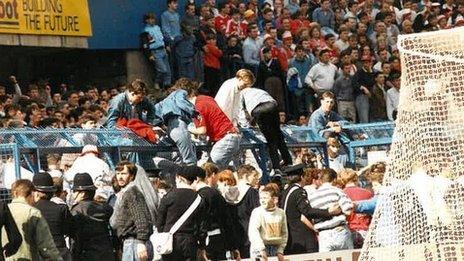 Fans climbing out of the terrace pens