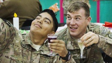 U.S. soldiers from the 3rd Cavalry Regiment pose for a photograph while eating a Christmas day lunch at forward operating base Gamberi in the Laghman province of Afghanistan December 25, 2014