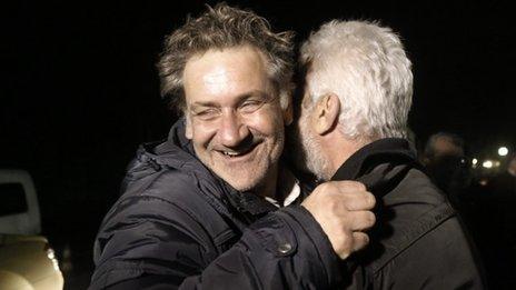 A rescued passenger (left) of the Norman Atlantic ferry accident is welcomed by a relative during his arrival at the airport of Elefsina west of Athens (29 December 2014)