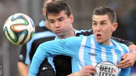 Ballymena's Mark McCullagh challenges Warrenpoint forward Daniel Hughes