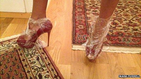 Woman wearing plastic bags over her high heeled shoes