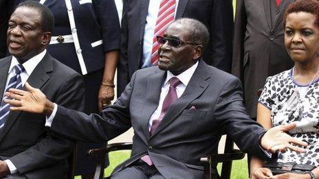 Zimbabwe"s President Robert Mugabe (centre) sits with his wife Grace Mugabe and Emmerson Mnangagwa (left) - 12 December 2014