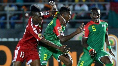 Thierry Bifouma (L) challenges Burkina Faso's defender Steeve Yago and Burkina Faso's defender Mohamed Koffi