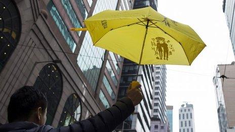 A pro-democracy protester holds up a yellow umbrella during Sunday's march (01 February 2015)