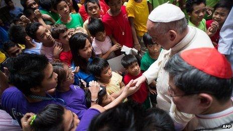 This handout picture released by the Vatican press office (Osservatore Romano) shows Pope Francis meeting children at an event in Manila on January 16, 2015.