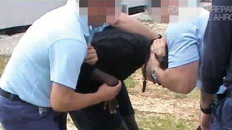 Young immigrant being manhandled in an Australian detention centre