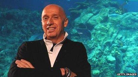 Allan Zeman in front of an aquarium