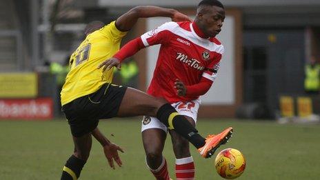Lucas Akins of Burton Albion collides with David Tutonda