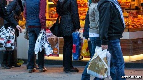 Shoppers pass a bakery in Hamburg