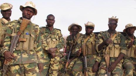 A group of Chadian soldiers rest with their guns