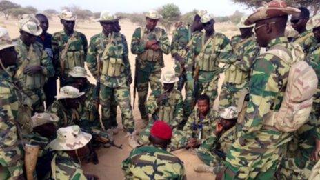 Soldiers surround a captain in the desert