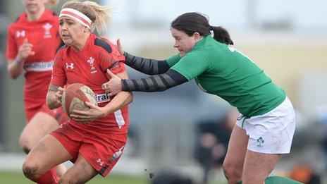 Adi Taviner of Wales is tackled by Jackie Shiels