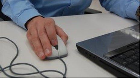 Man's hand on a computer mouse