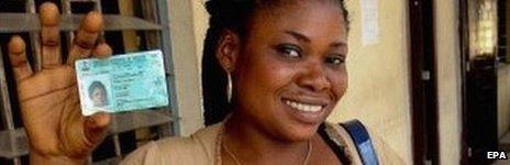 A Nigerian voter poses for a photo with a newly acquired permanent voters card - February 2015