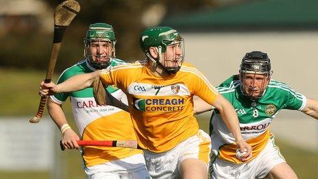 Antrim forward Paul Shiels moves clear of two Offaly opponents