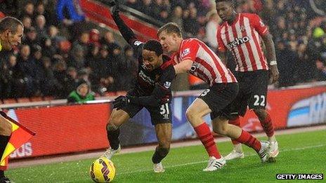 Matt Targett (stripes) of Southampton tussles with Raheem Sterling of Liverpool