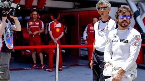 McLaren driver Fernando Alonso outside the Ferrari garage