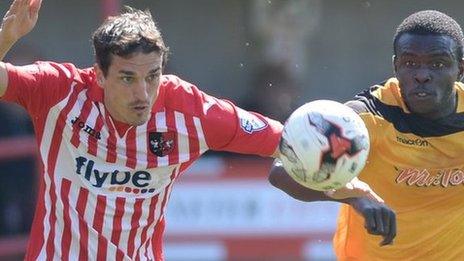 Ismail Yakubu (r) and Craig Woodman battle for possession
