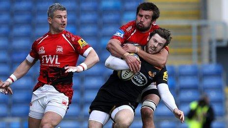 Elliot Daly of Wasps is tackled by Opeti Fonua