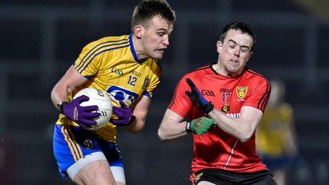 Roscommon's Enda Smith and Down forward Conor Garvey prepare to collide