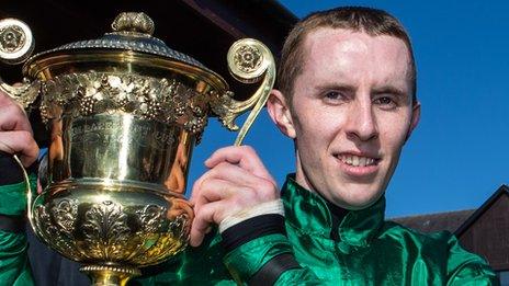 Jockey Mark Walsh with the World Series Hurdle trophy