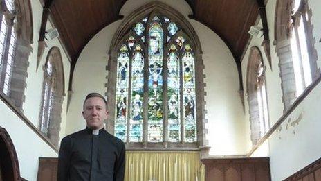 Rev David Morris with the WW1 memorial window at St Paul's Church in Grangetown