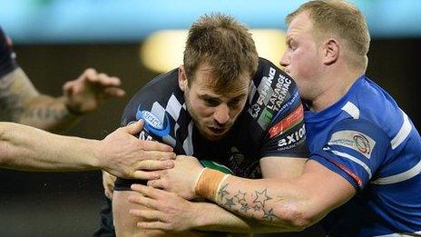 Simon Humberstone of Pontypridd is tackled by Bridgend's Adam O'Driscoll