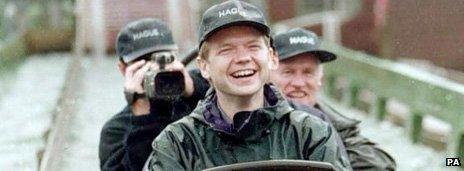William Hague wears a baseball cap with the slogan "Hague" while riding a log flume in 1997