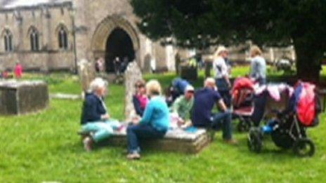 Picture of people picnicking on gravestones