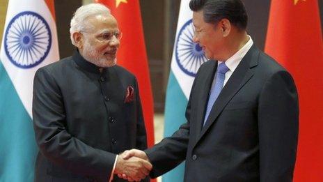 Indian Prime Minister Narendra Modi, left, and Chinese President Xi Jinping shake hands