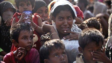 A rescued migrant weeps upon arrival Simpang Tiga, Aceh province, Indonesia