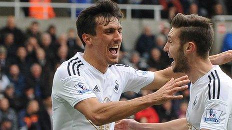 Jack Cork (L) celebrates scoring for Swansea City