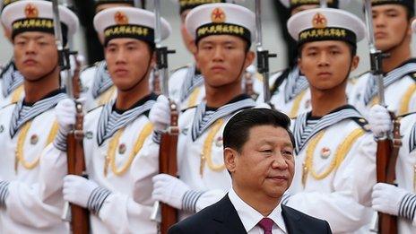 Chinese People's Liberation Army navy soldiers of a guard of honour look at Chinese President Xi Jinping