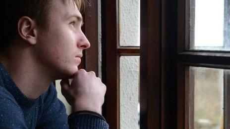 Man staring out of window