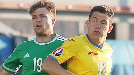 Northern Ireland's Jamie Ward in action against Andrei Prepelița of Romania