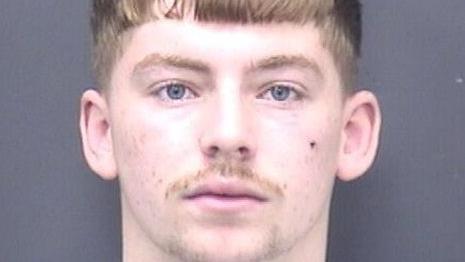 A mugshot of Betteridge. He has blue eyes, a light brown fringe, and thin moustache.