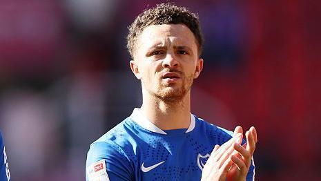 Jordan Williams, in Portsmouth strip, applauds the fans.