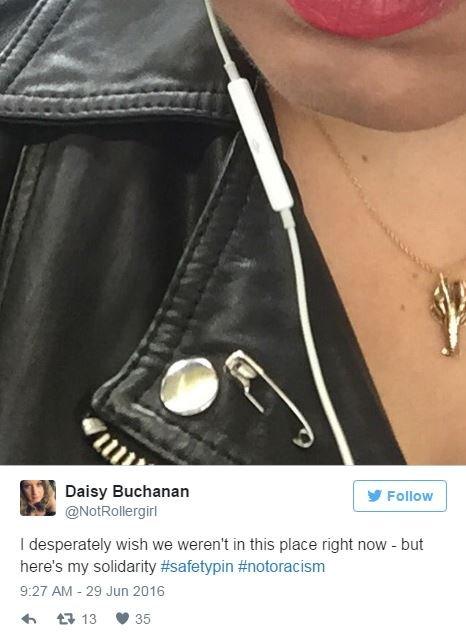 A tweet with a picture of a safety pin in a woman's leather jacket and the words, I desperately wish we weren't in this place right now - but here's my solidarity