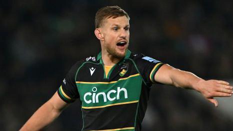 Rory Hutchinson guiding his fellow Northampton Saints teammates during their match against Harlequins