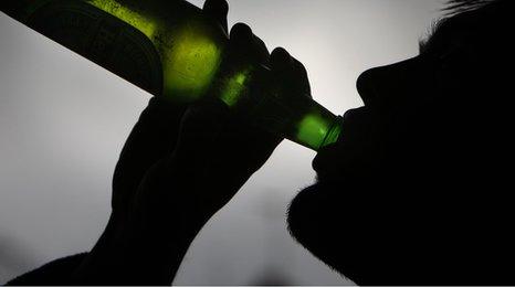 Boy drinking a bottle of beer