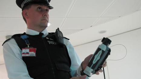 Policeman with passport scanning device