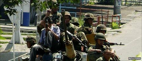 Soldiers ride on an armoured vehicle along a street in Osh, southern Kyrgyzstan [11 June 2010]