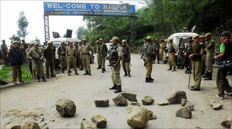 Indian security forces stand guard at the Mao Gate Bazar just after a crowd waiting to welcome a separatist leader was dispersed at the Nagaland-Manipur state border, 109 km from Imphal, capital city of Manipur, on May 6, 2010.