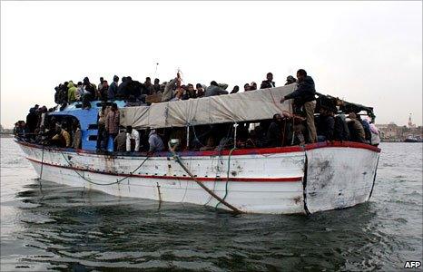 Migrants on a boat in Tripoli's port