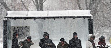 People wait at bus shelter