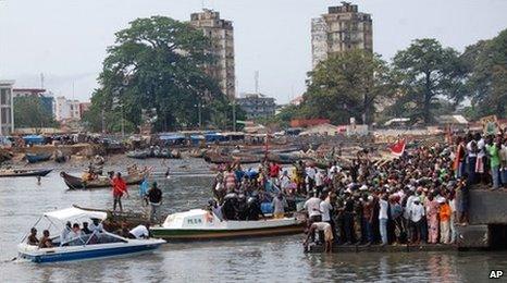 Supporters of former prime minister Lansana Kouyate gather at a port in Conakry