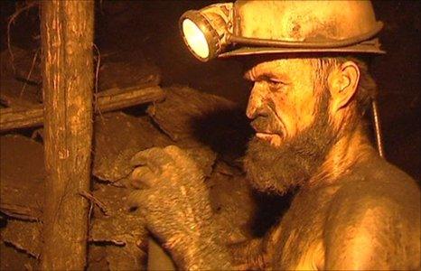 Miner at work underneath the hills of Pul-e Khumri