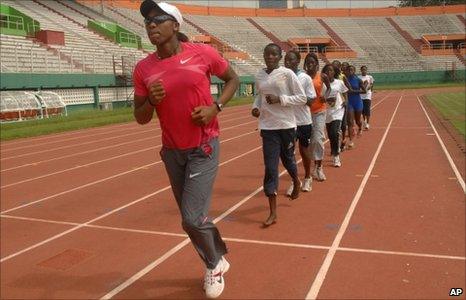 South African runner Caster Semenya leads young Ivorian athletes in training drills at a stadium in Abidjan, Ivory Coast Thursday, May 27, 2010