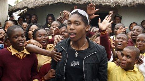 South African athlete Caster Semenya, centre, surrounded by local children at her welcome home celebration at the Masehlong village in South Africa