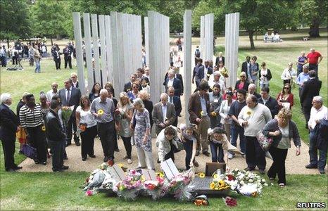 People laying flowers at the Hyde Park memorial